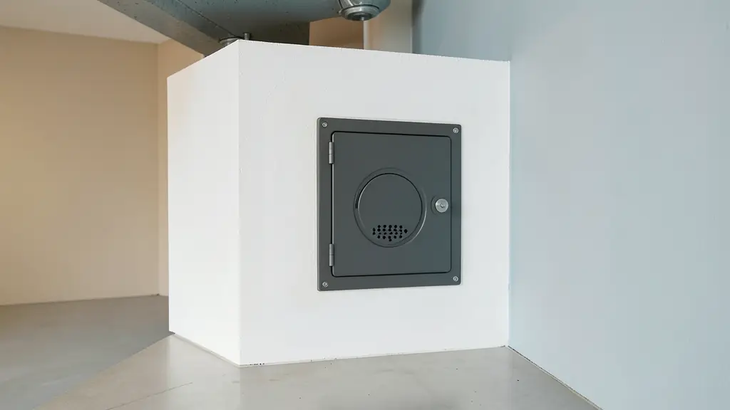 Editorial shot of a professional flush-mounted access hatch integrated into a white plasterboard technical shaft, clean edges, industrial interior